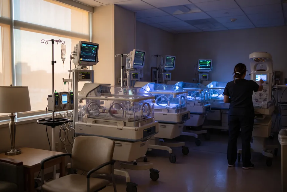 Neonatal intensive care unit with incubators and monitoring equipment